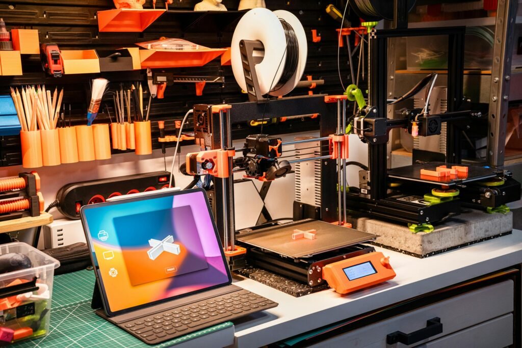 pexels-photo-19124461-19124461 A high-tech workshop featuring 3D printers and a tablet on a desk, showcasing modern innovation.